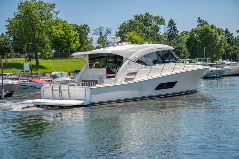 Slide: The Image of 2020 Riviera 525 SUV yacht cruising on a serene lake. - 10