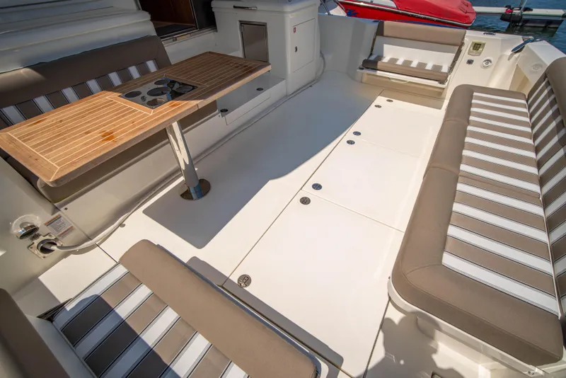 Slide: The Image of 2020 Riviera 525 SUV interior with striped seating and wooden table. - 16
