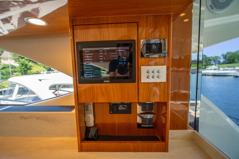 Slide: The Image of 2020 Riviera 525 SUV interior control panel with touchscreen and wooden finish. - 24