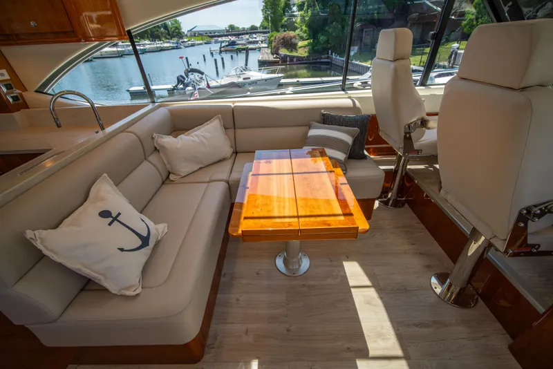 Slide: The Image of Luxurious interior of 2020 Riviera 525 SUV yacht with elegant seating and wooden table. - 27