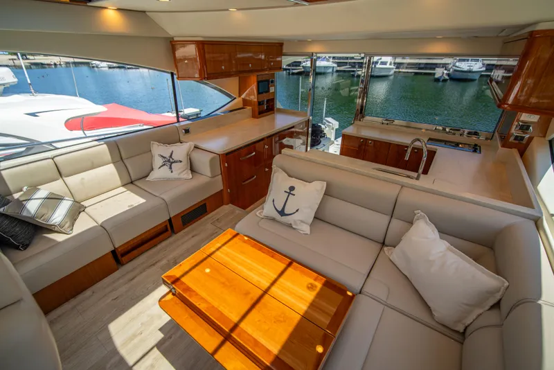 Slide: The Image of Luxurious interior of 2020 Riviera 525 SUV yacht with marina view. - 30