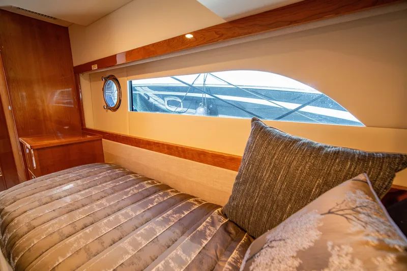 Slide: The Image of Luxurious interior cabin of 2020 Riviera 525 SUV yacht with elegant bedding. - 36