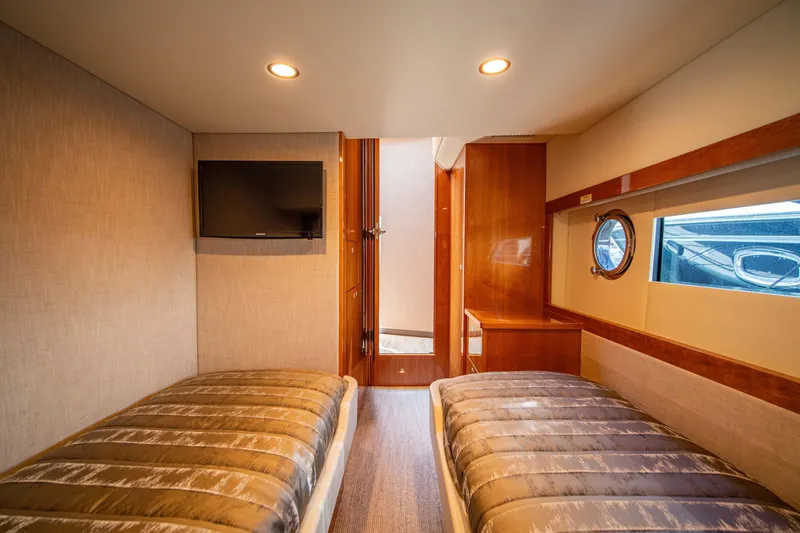 Slide: The Image of Interior of 2020 Riviera 525 SUV with twin beds and porthole window. - 38