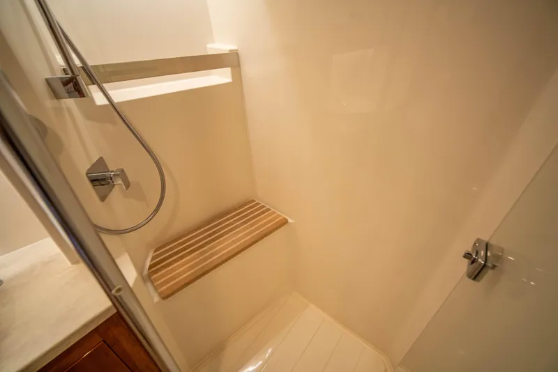 Slide: The Image of Luxurious shower in 2020 Riviera 525 SUV yacht with wooden bench and modern fixtures. - 44