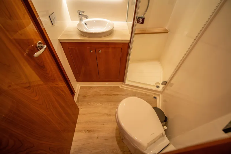 Slide: The Image of Luxurious bathroom in 2020 Riviera 525 SUV yacht with wood accents and modern fixtures. - 46