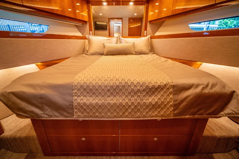 Slide: The Image of Luxurious bedroom interior of 2020 Riviera 525 SUV yacht with elegant bedding. - 47