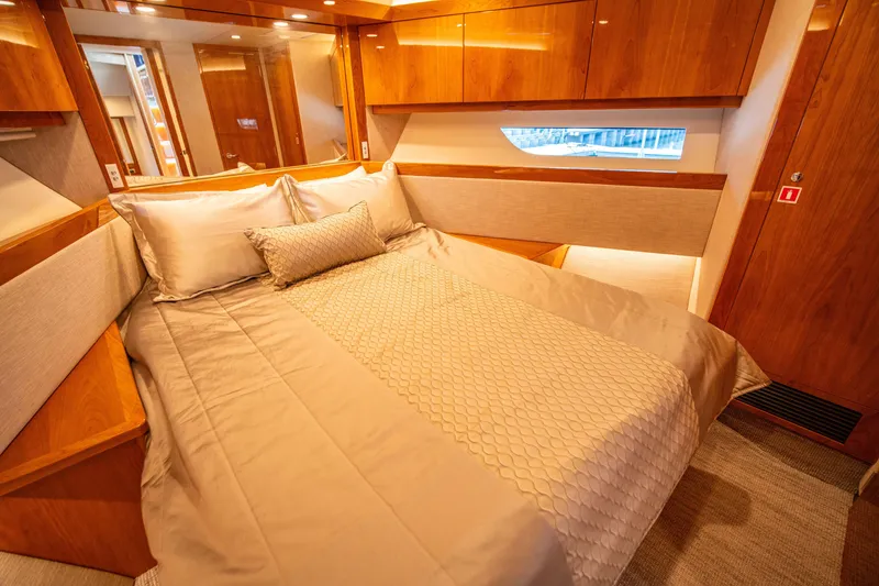 Slide: The Image of Luxurious bedroom interior of 2020 Riviera 525 SUV yacht with elegant wood finishes. - 48