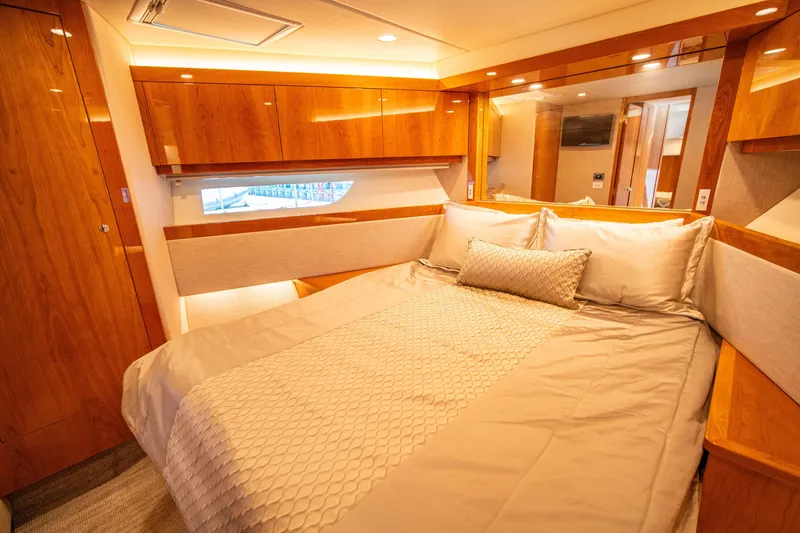 Slide: The Image of Luxurious bedroom interior of 2020 Riviera 525 SUV yacht with elegant wood finishes. - 49