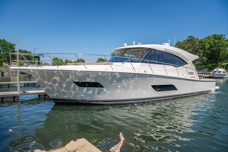 Slide: The Image of 2020 Riviera 525 SUV yacht docked on a sunny day. - 6