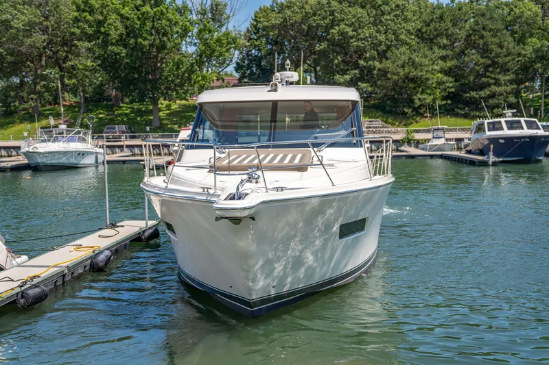 Slide: The Image of 2020 Riviera 525 SUV docked in a serene marina setting. - 7