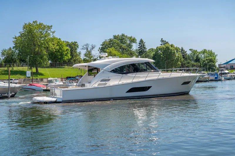 Slide: The Image of 2020 Riviera 525 SUV yacht cruising on a serene lake. - 9