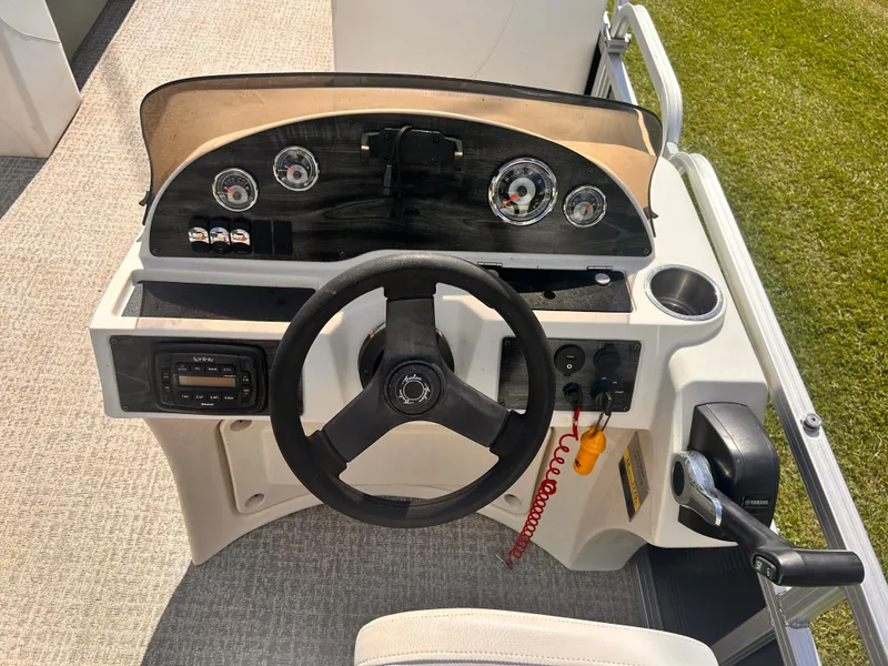 Slide: The Image of 2019 Avalon GS Cruise 25' boat dashboard with steering wheel and control panel. - 8