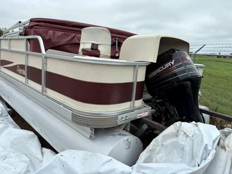 Slide: The Image of 1996 Premier ALANTE pontoon boat with Mercury 4-stroke engine, parked outdoors. - 10