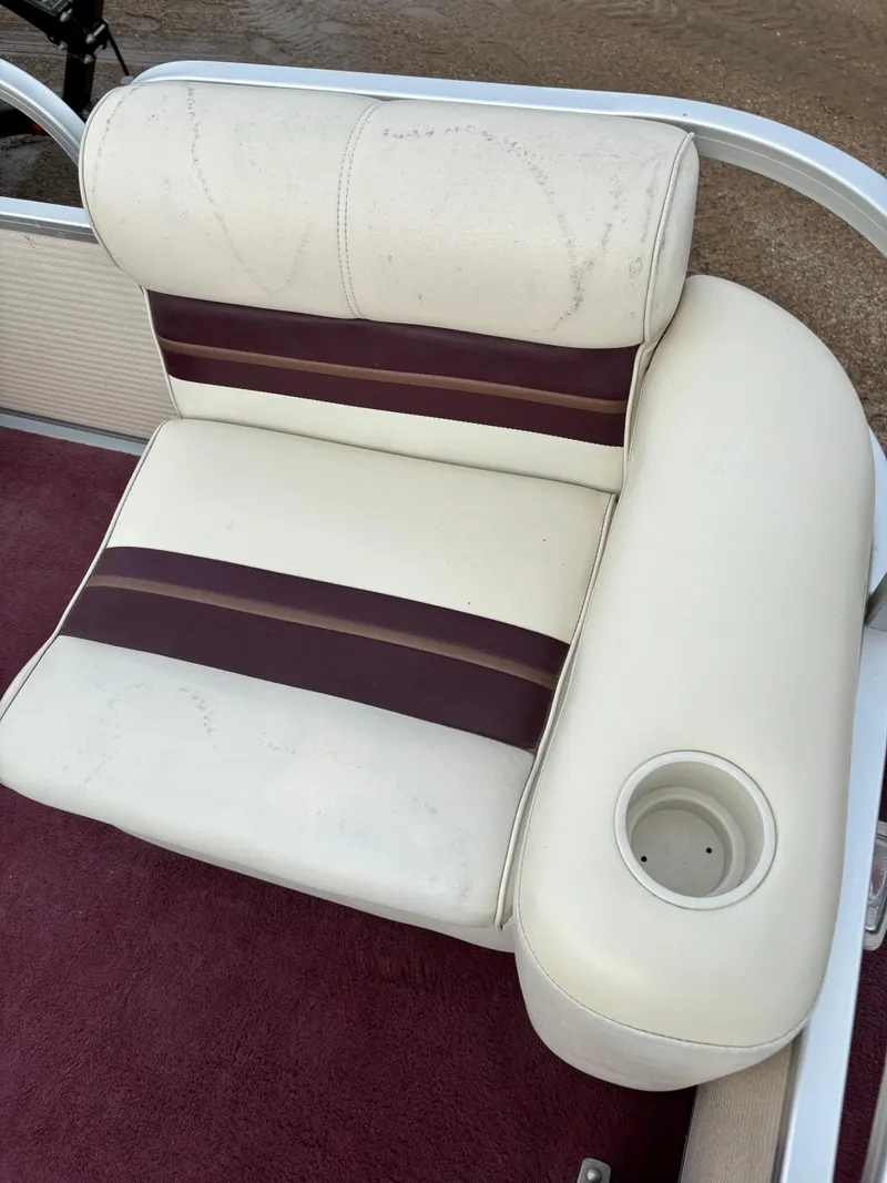 Slide: The Image of 1996 Premier ALANTE boat seat with maroon accents and cup holder. - 13