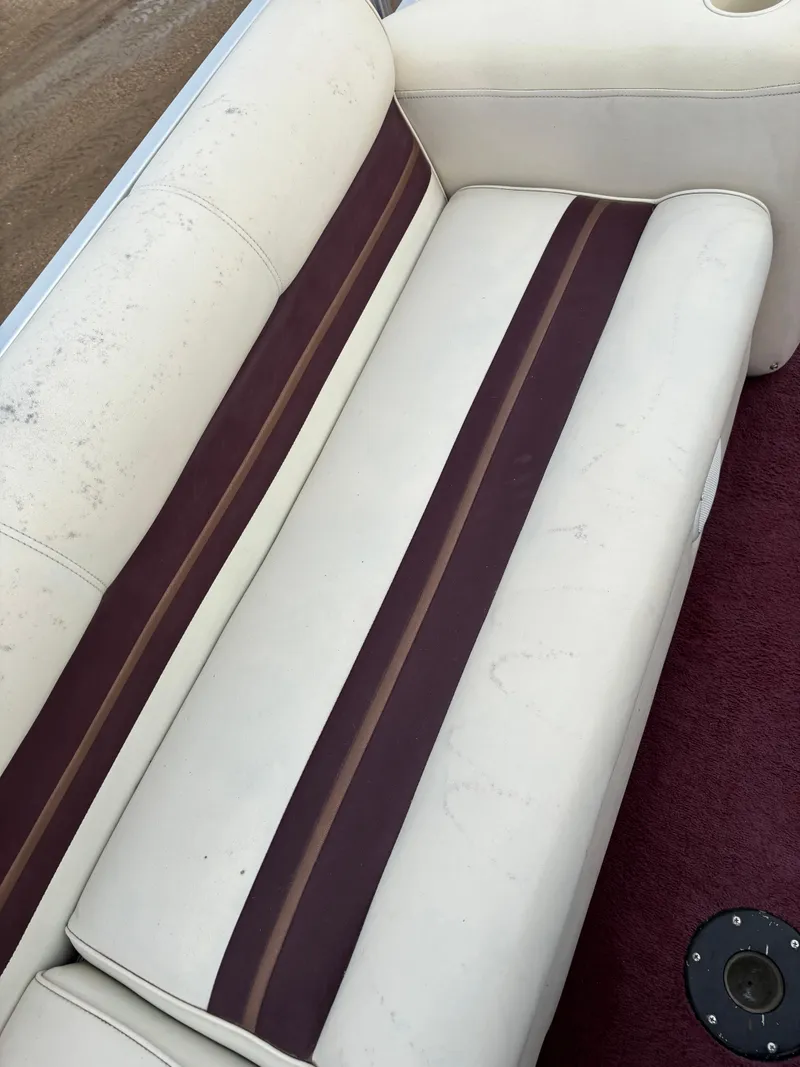 Slide: The Image of 1996 Premier ALANTE boat seat with white and maroon upholstery, showing slight wear. - 16