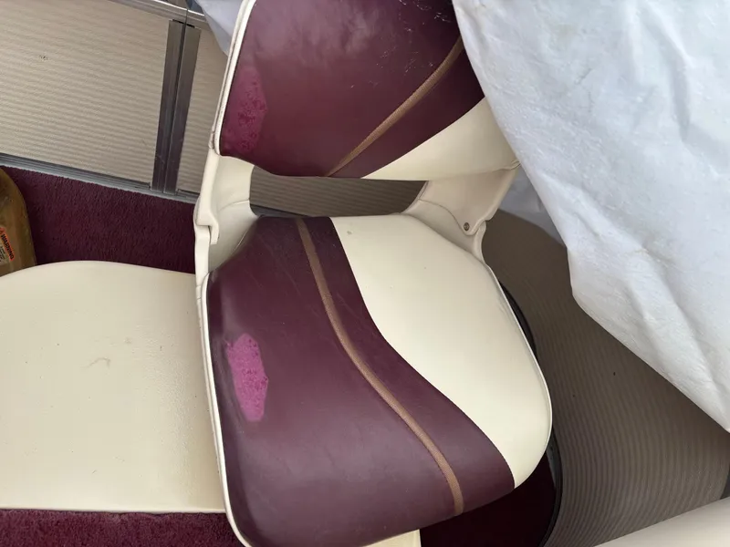 Slide: The Image of 1996 Premier ALANTE boat seat with maroon and cream upholstery, showing signs of wear. - 18