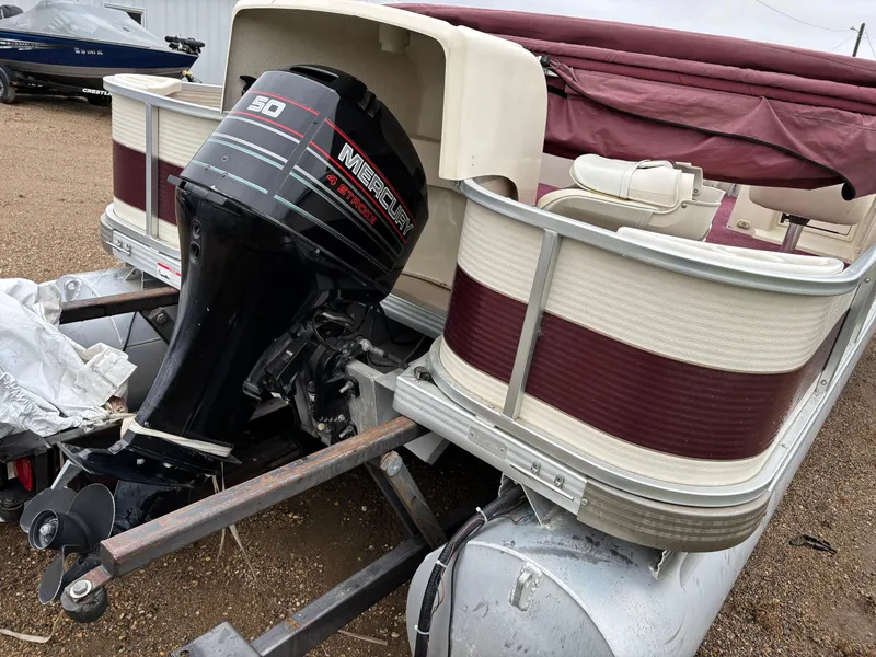 Slide: The Image of 1996 Premier ALANTE pontoon boat with Mercury 50 HP outboard motor, parked on trailer. - 19