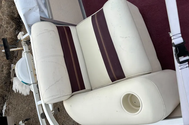 Slide: The Image of White and maroon boat seat on a 1996 Premier ALANTE, featuring a cup holder. - 23