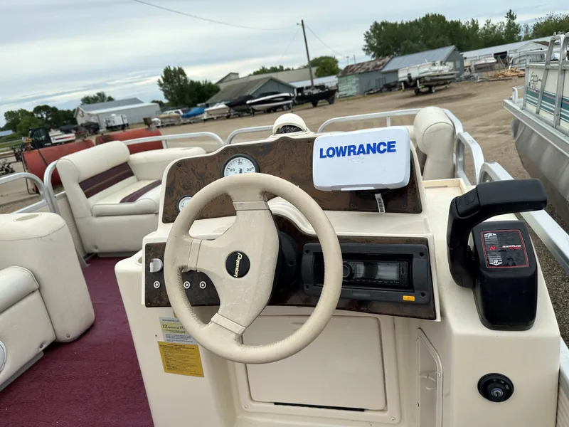 Slide: The Image of Steering console of a 1996 Premier ALANTE boat with Lowrance equipment. - 3