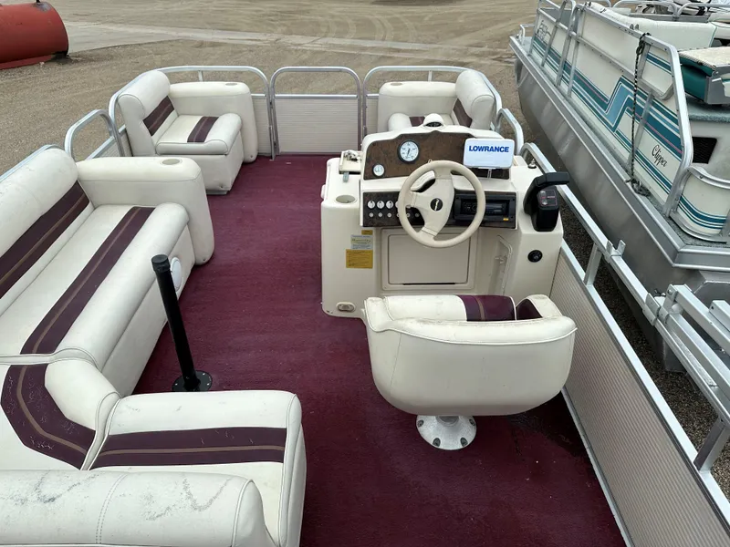 Slide: The Image of 1996 Premier ALANTE pontoon boat interior with red carpet and white seating. - 5