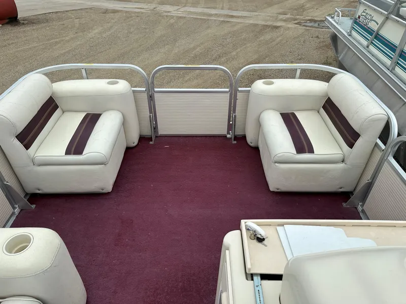 Slide: The Image of 1996 Premier ALANTE pontoon boat interior with red carpet and white seating. - 6