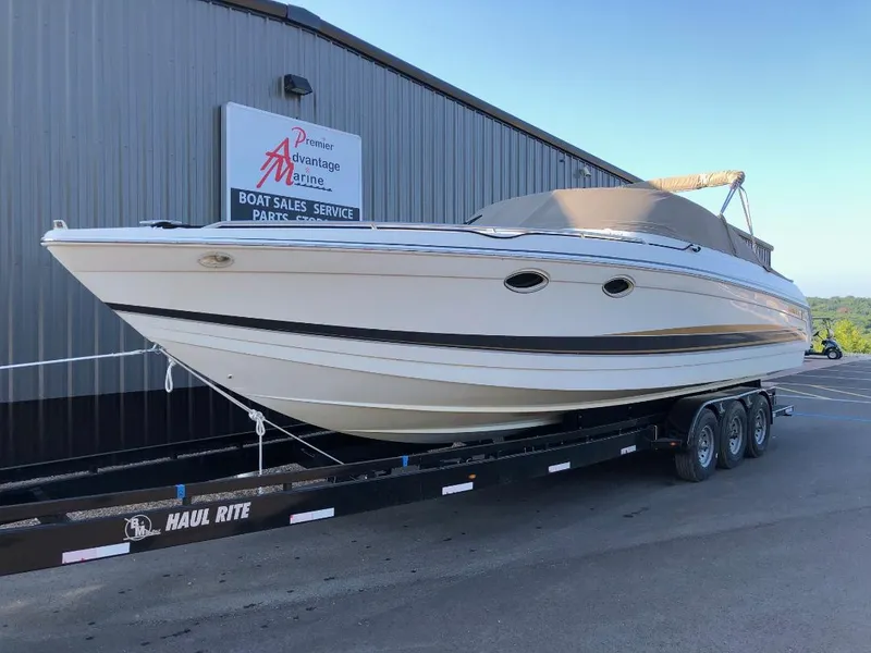 Slide: The Image of 2002 Formula 330 SS boat on trailer outside marine sales building. - 1