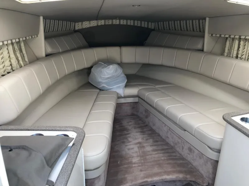 Slide: The Image of Interior of 2002 Formula 330 SS boat with beige leather seating and carpeted floor. - 10
