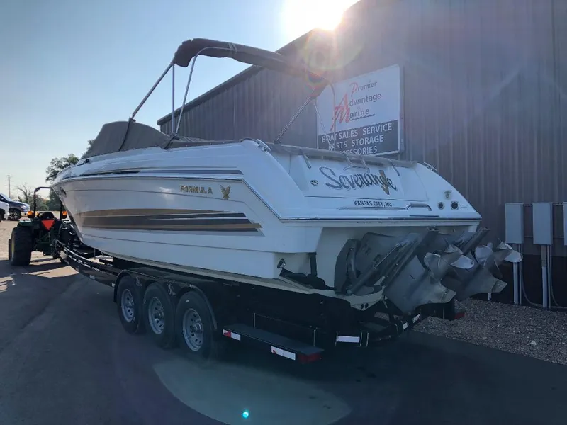 Slide: The Image of 2002 Formula 330 SS boat on trailer, parked outside a building. - 3