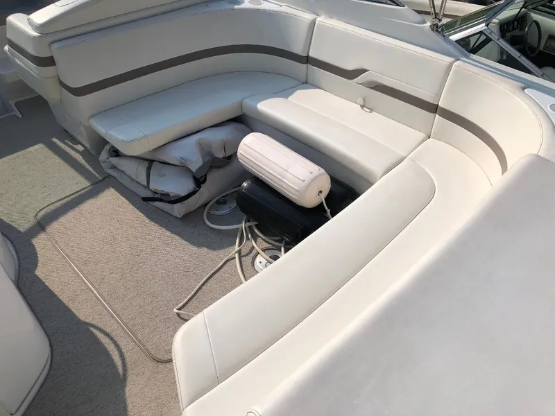 Slide: The Image of 2002 Formula 330 SS boat interior with white cushioned seating. - 6