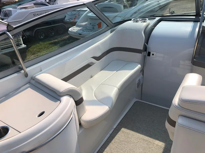 Slide: The Image of Interior of a 2002 Formula 330 SS boat with white seating and sleek design. - 7