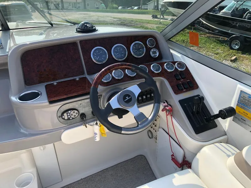 Slide: The Image of 2002 Formula 330 SS boat dashboard with steering wheel and instrument panel. - 8