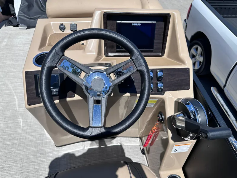 Slide: The Image of 2023 Harris Cruiser 230 dashboard with steering wheel and control panel. - 10