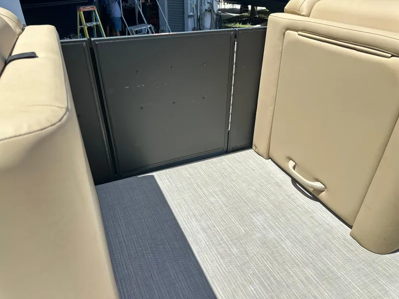 Slide: The Image of Interior of 2023 Harris Cruiser 230 boat with beige seating and carpet flooring. - 11