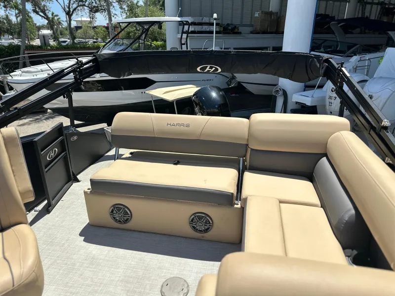Slide: The Image of 2023 Harris Cruiser 230 boat interior with beige seating and built-in speakers. - 12