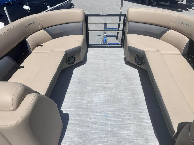 Slide: The Image of 2023 Harris Cruiser 230 boat interior with beige seating and spacious layout. - 13