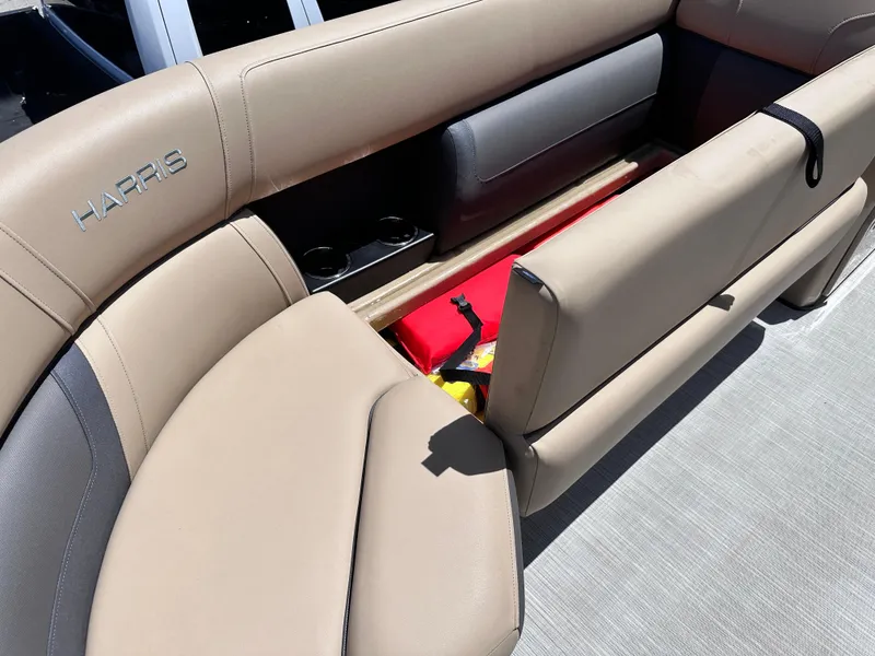 Slide: The Image of 2023 Harris Cruiser 230 boat interior with beige seating and storage compartment. - 15
