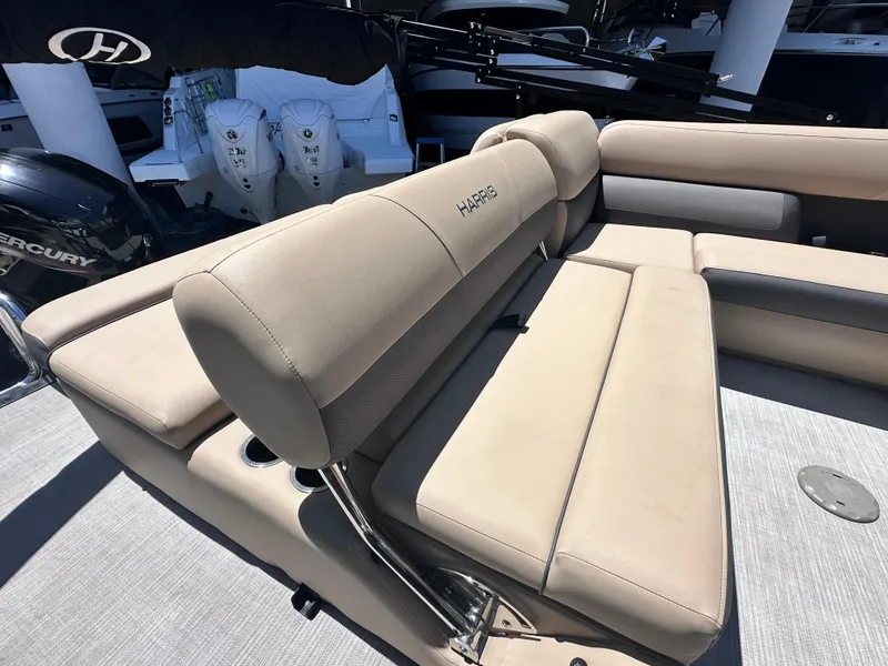 Slide: The Image of 2023 Harris Cruiser 230 boat interior with beige seating and Mercury engines. - 5