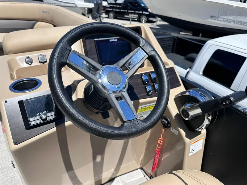 Slide: The Image of Steering wheel of 2023 Harris Cruiser 230 boat, featuring modern controls and dashboard. - 9