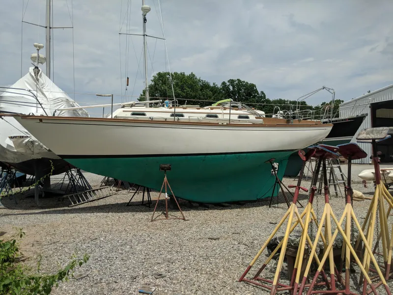 Slide: The Image of 1984 Cape Dory Cutter sailboat on stands in a boatyard. - 1