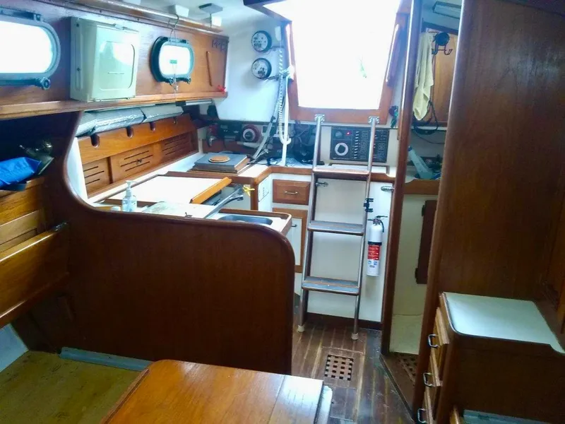 Slide: The Image of Interior of a 1984 Cape Dory Cutter sailboat with wooden cabinetry and nautical instruments. - 12