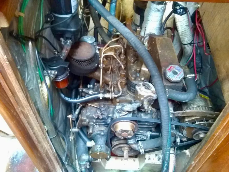 Slide: The Image of 1984 Cape Dory Cutter engine compartment with visible components and wiring. - 13