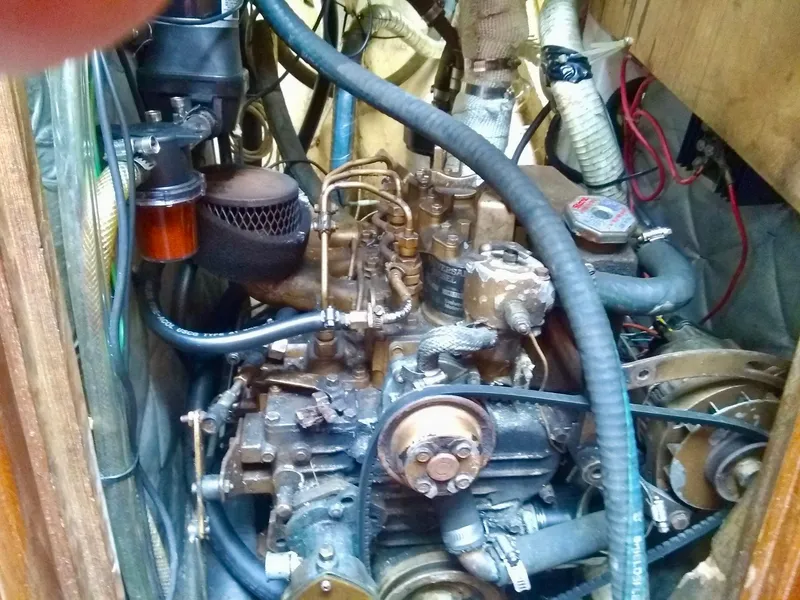 Slide: The Image of 1984 Cape Dory Cutter engine compartment with visible mechanical components and wiring. - 14