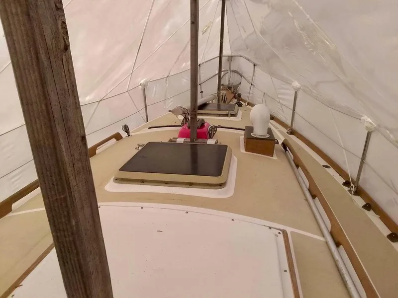 Slide: The Image of 1984 Cape Dory Cutter sailboat deck under cover, showcasing classic design elements. - 6