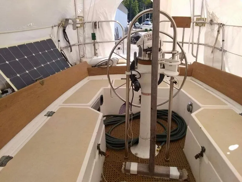 Slide: The Image of 1984 Cape Dory Cutter sailboat cockpit with steering wheel and solar panel. - 7