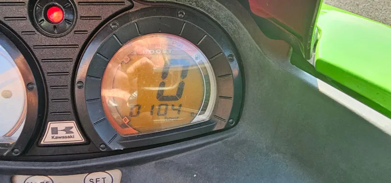 Slide: The Image of Close-up of 2008 Kawasaki ULTRA250X dashboard displaying speedometer and digital readout. - 4