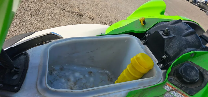 Slide: The Image of 2008 Kawasaki ULTRA250X storage compartment with yellow item inside. - 5