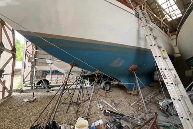 Slide: The Image of 1984 Mason 43 Cutter sailboat under maintenance in a boatyard. - 1