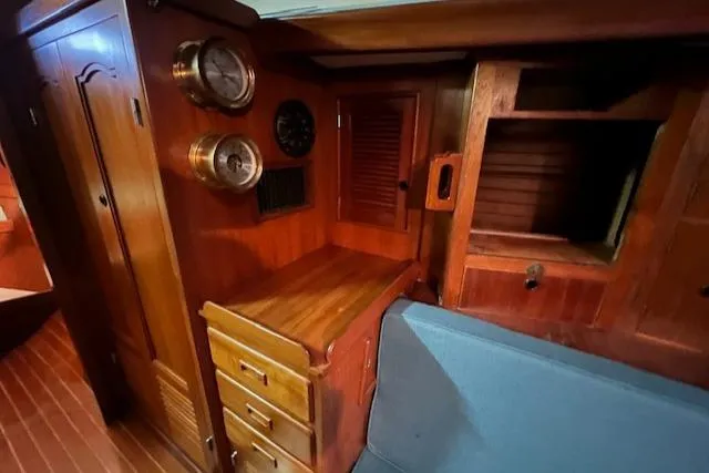 Slide: The Image of Wooden interior of 1984 Mason 43 Cutter sailboat with cabinets and seating. - 10