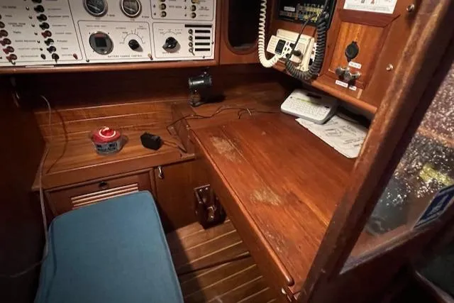 Slide: The Image of Navigation station on 1984 Mason 43 Cutter with control panels and communication equipment. - 11