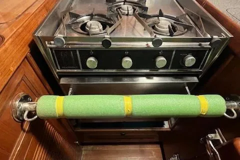 Slide: The Image of Stove in 1984 Mason 43 Cutter yacht kitchen with green safety bar. - 15